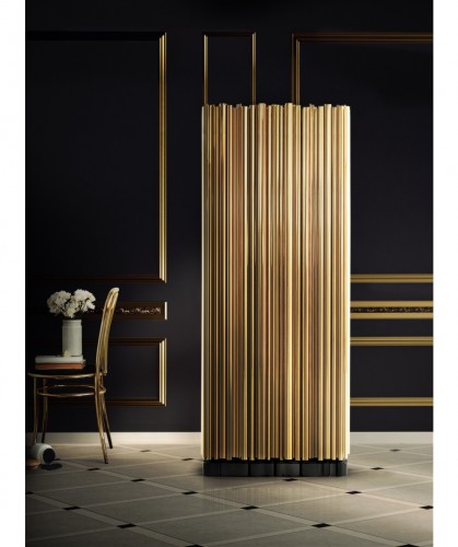This is Symphony by Boca do Lobo, a cabinet made from wood finished covered by a tubular structure in gold plated brass.