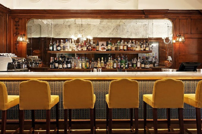 Contemporay Wild Honey Bar, London. Yellow mohair bar stools by Martin Brudnizki Design Studio.